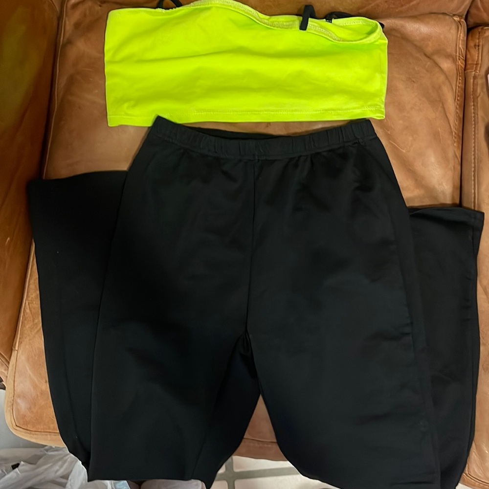 Neon green top with black strings and black flare legging pants